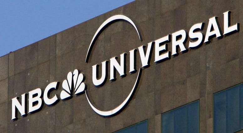 This Dec. 3, 2009, file photo, the NBC Universal logo hangs on a building in Los Angeles. NBC Universal