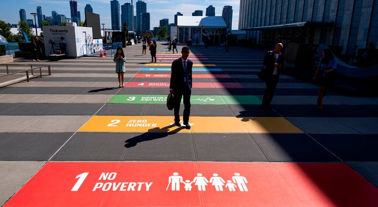 People walk along a plaza at United Nations Headquarters Saturday, Sept. 21, 2019. People walk along a plaza at United Nations Headquarters Saturday, Sept. 21, 2019.