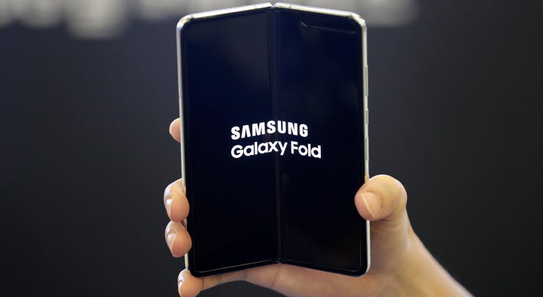 An employee holds the Samsung Electronics Co.'s Galaxy Fold for a photograph at a shopping mall in Seoul, South Korea. An employee holds the Samsung Electronics Co.'s Galaxy Fold for a photograph at a shopping mall in Seoul, South Korea.