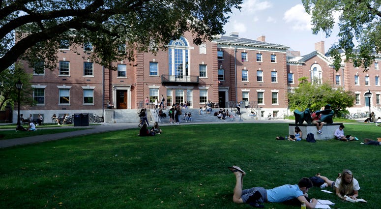 Tax and charity records show that prestigious universities around the world, including Brown, have accepted at least $60 million from the family that owns OxyContin maker Purdue Pharma over the past five years. People rest on grass while reading at Brown University in Providence, R.I.