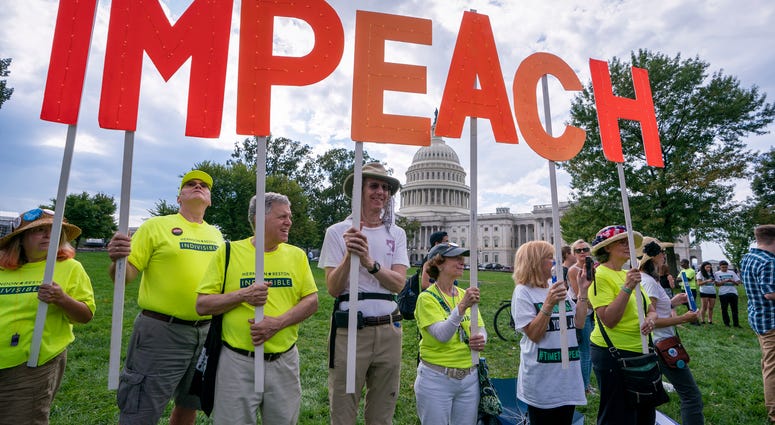 Activists rally for the impeachment of President Donald Trump, at the Capitol in Washington, Thursday, Sept. 26, 2019. Activists rally for the impeachment of Trump