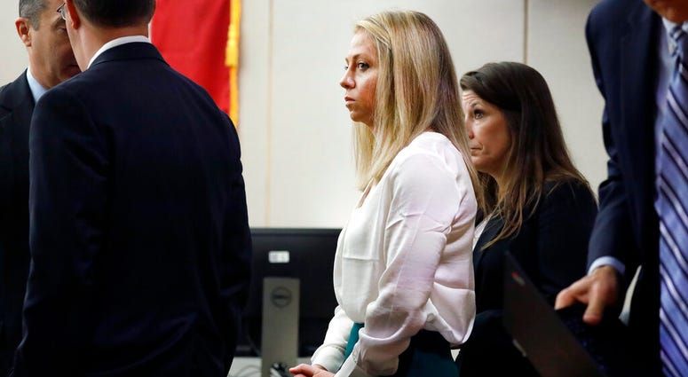 Former Dallas police officer Amber Guyger, center, appears at the Frank Crowley Courts Building in Dallas, Saturday, Sept. 28, 2019. Amber Guyger