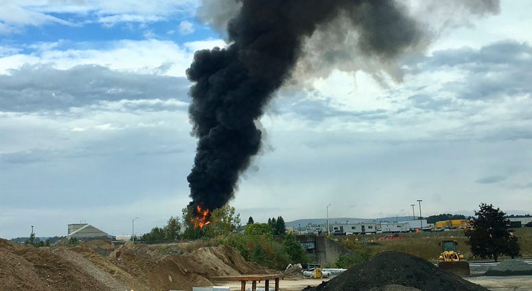 In this photo provided by Antonio Arreguin, smoke fills the sky after a World War II-era bomber plane crashed, Wednesday, Oct. 2, 2019 outside Bradley International Airport north of Hartford, Conn. In this photo provided by Antonio Arreguin, smoke fills the sky after a World War II-era bomber plane crashed, Wednesday, Oct. 2, 2019 outside Bradley International Airport north of Hartford, Conn.
