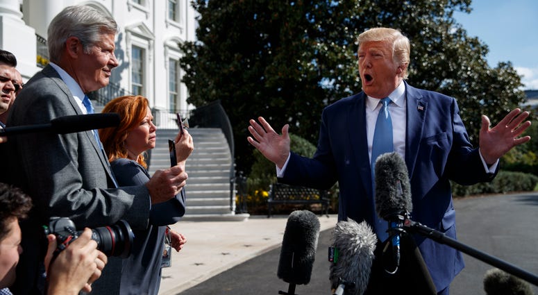 President Donald Trump talks to reporters on the South Lawn of the White House, Friday, Oct. 4, 2019, in Washington. President Donald Trump