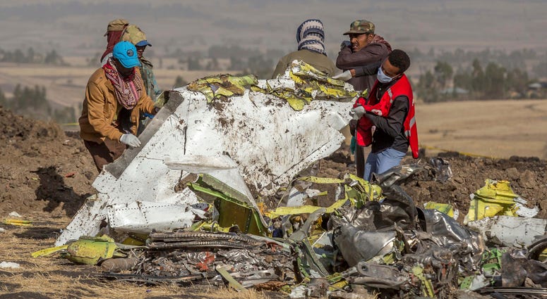 In this March 11, 2019, file photo, rescuers work at the scene of an Ethiopian Airlines flight crash outside of Addis Ababa, Ethiopia. Ethiopian Airlines flight crash