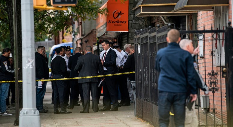 NYPD investigates the scene of a shooting in the Brooklyn borough of New York on Saturday, Oct. 12, 2019. Authorities responded to a call about shots fired just before 7 a.m. and found four men dead in the Crown Heights neighborhood of Brooklyn. NYPD investigates the scene of a shooting in the Brooklyn borough of New York on Saturday, Oct. 12, 2019.