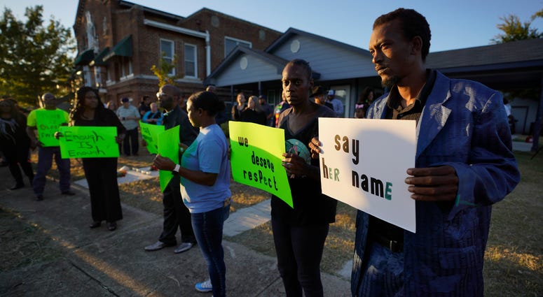 Protesters gather outside the house, right, where Atatiana Jefferson was shot Saturday and killed by police, during a community vigil for Jefferson on Sunday, Oct. 13, 2019, in Fort Worth, Texas. Vigil for Atatiana Jefferson