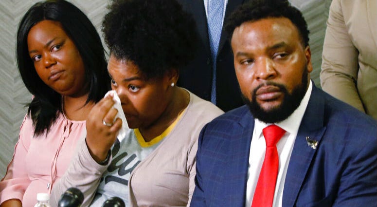 Amber Carr, center, wipes a tear as her sister, Ashley Carr, left, and attorney Lee Merritt, right, listen to their brother Adarius Carr talk about their sister, Atatiana Jefferson during a news conference Monday, Oct. 14, 2019 in downtown Dallas. Amber Carr, center, wipes a tear as her sister, Ashley Carr, left, and attorney Lee Merritt, right, listen to their brother Adarius Carr talk about their sister, Atatiana Jefferson during a news conference.