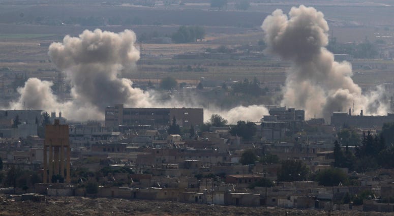 Sanliurfa province, southeastern Turkey, smoke and dust billows from targets in Ras al-Ayn, Syria, caused by bombardment by Turkish forces, Tuesday, Oct. 15, 2019. Sanliurfa province, southeastern Turkey, smoke and dust billows from targets in Ras al-Ayn, Syria, caused by bombardment by Turkish forces, Tuesday, Oct. 15, 2019.