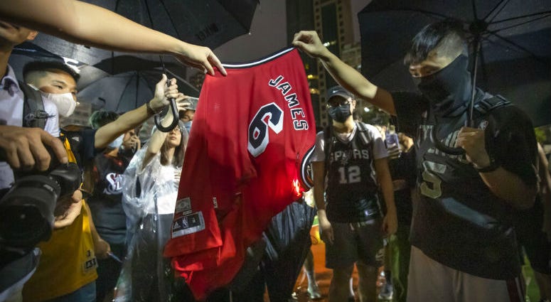 Demonstrators set a Lebron James jersey on fire during a rally at the Southorn Playground in Hong Kong, Tuesday, Oct. 15, 2019. Demonstrators set a Lebron James jersey on fire during a rally at the Southorn Playground in Hong Kong.