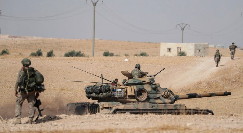 Turkish tanks and troops stationed near Syrian town of Manbij, Syria, Tuesday. Oct. 15, 2019. Turkish tanks and troops stationed near Syrian town of Manbij, Syria.