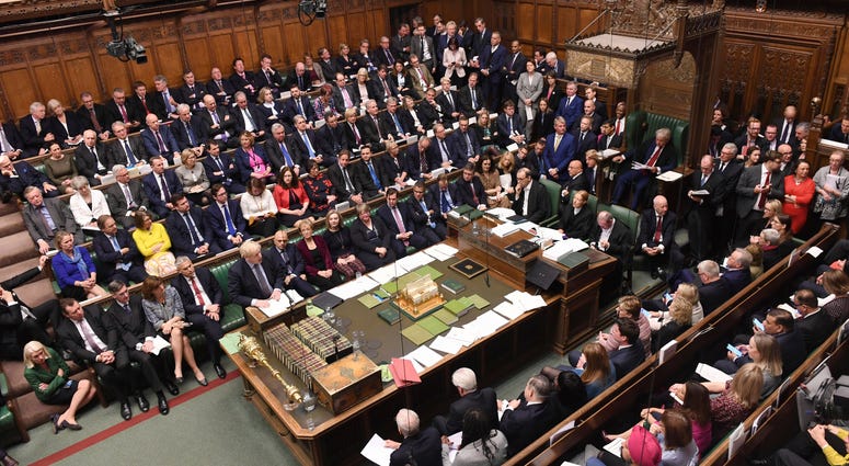 At the rare weekend sitting of Parliament, Prime Minister Boris Johnson implored legislators to ratify the Brexit deal he struck this week with the other 27 EU leaders. Britain's Prime Minister Boris Johnson, stands at left, to give a statement to lawmakers inside the House of Commons to update details of his new Brexit deal with EU, in London Saturday Oct. 19, 2019.