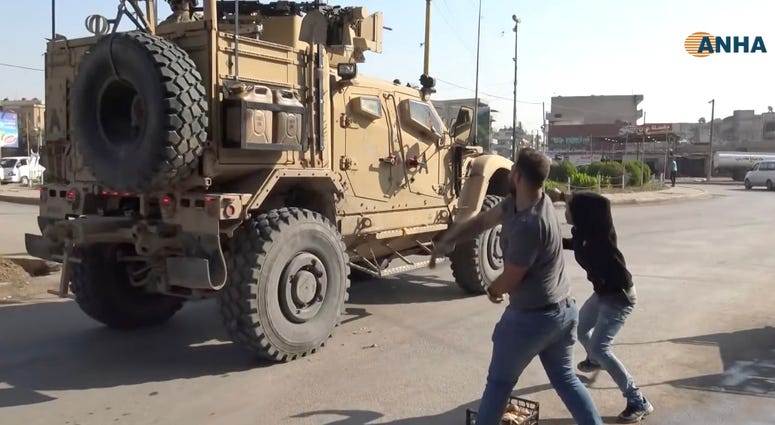 residents who are angry over the U.S. withdrawal from Syria hurl potatoes at American military vehicles in the town of Qamishli, northern Syria, Monday, Oct. 21, 2019. residents who are angry over the U.S. withdrawal from Syria hurl potatoes at American military vehicles in the town of Qamishli, northern Syria, Monday, Oct. 21, 2019.