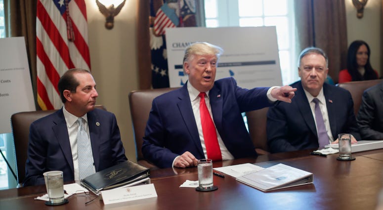 President Donald Trump points to members of his Cabinet while speaking during a Cabinet meeting, Oct. 21, 2019, in Washington, as Health and Human Services Secretary Alex Azar, left, and Secretary of State Mike Pompeo, right, listen. President Donald Trump with members of his Cabinet