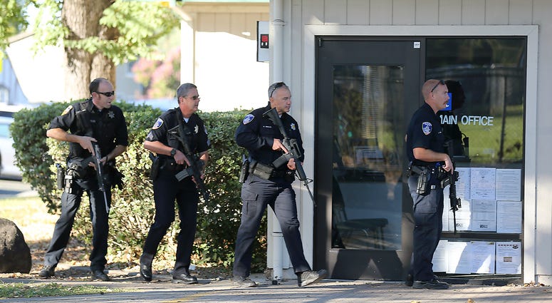 Police officers search for a suspect in a shooting at Ridgway High School in Santa Rosa, Calif., Oct. 22, 2019. School shooting