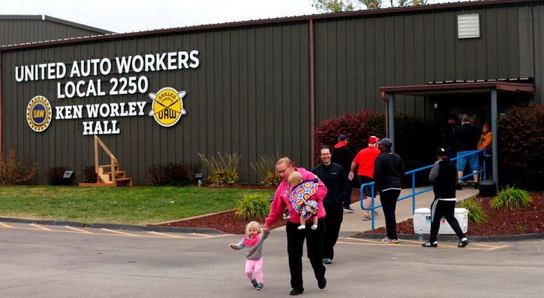 United Auto Worker Lindsey Higgins, exits the the UAW Local 2250 Ken Worley Hall with her two children after voting on the offer made to union workers by General Motors on Thursday, Oct. 24, 2019. United Auto Worker Lindsey Higgins, exits the the UAW Local 2250 Ken Worley Hall with her two children after voting on the offer made to union workers by General Motors on Thursday, Oct. 24, 2019.