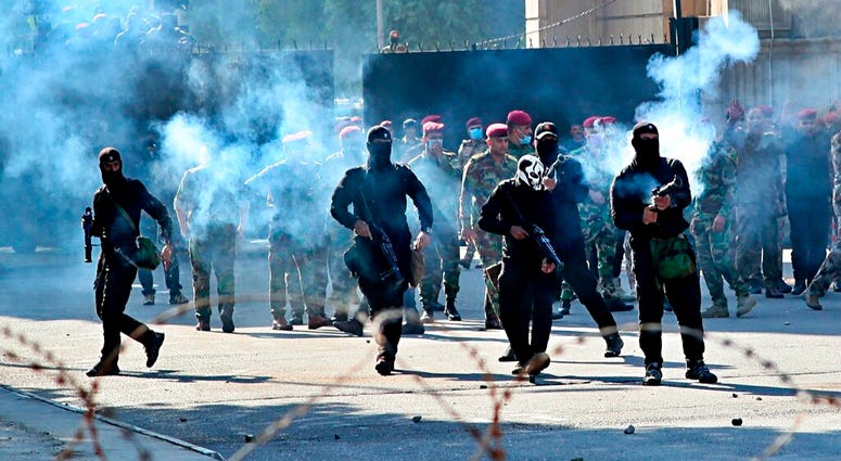 Iraqi security forces fire tear gas to disperse anti-government protesters during a demonstration in central Baghdad, Iraq, Friday, Oct. 25, 2019. Iraqi security forces fire tear gas to disperse anti-government protesters during a demonstration in central Baghdad, Iraq, Friday, Oct. 25, 2019.