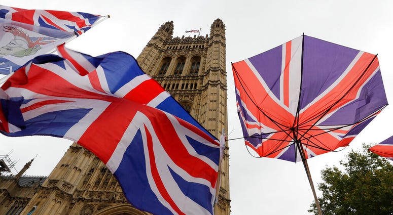Union flags and an umbrella tied to railings in front of Parliament in London, Friday, Oct. 25, 2019. Union flags and an umbrella tied to railings in front of Parliament in London, Friday, Oct. 25, 2019.