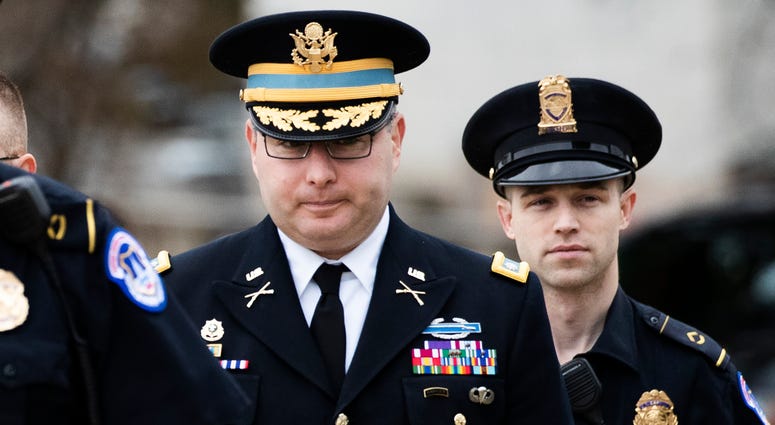 Army Lt. Col. Alexander Vindman, center, arrives on Capitol Hill, Oct. 29, 2019, to appear before several House committees in a joint interview with the transcript to be part of the impeachment inquiry into Trump. Army Lt. Col. Alexander Vindman
