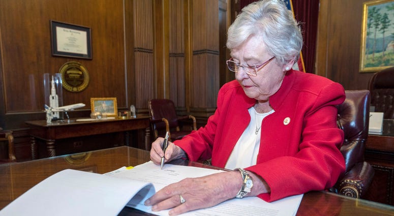 Alabama Gov. Kay Ivey signs a bill that virtually outlaws abortion in the state, in Montgomery, Ala. Alabama Gov. Kay Ivey signs a bill that virtually outlaws abortion in the state, in Montgomery, Ala.