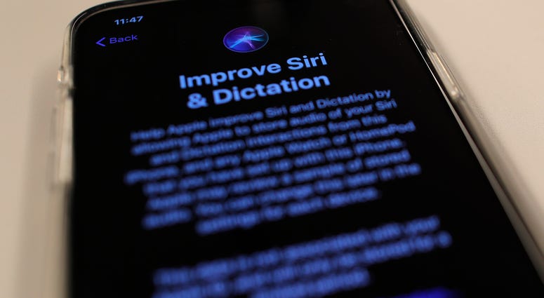 Apple is resuming the use of humans to review Siri commands and dictation with the latest iPhone software update. A screen displays a notice when installing the update, iOS 13.2 on an iPhone on Tuesday, Oct. 29, 2019, in New York.
