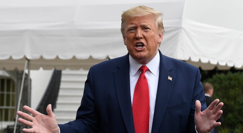 In this Oct. 25, 2019, photo, President Donald Trump talks to reporters on the South Lawn of the White House in Washington. In this Oct. 25, 2019, photo, President Donald Trump talks to reporters on the South Lawn of the White House in Washington.