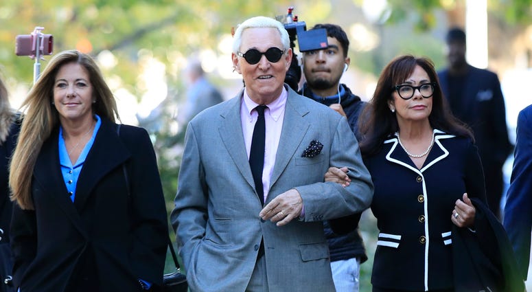 Roger Stone, center, with his wife, Nydia Stone, right, arrive at the federal court in Washington, Tuesday, Nov. 5, 2019. Roger Stone