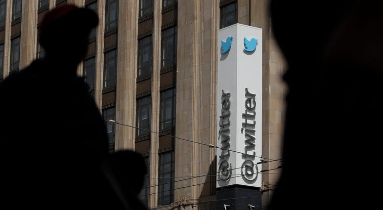 Pedestrians walk across the street from the Twitter office building in San Francisco. Pedestrians walk across the street from the Twitter office building in San Francisco.
