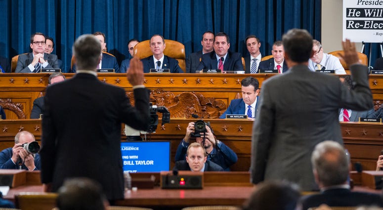 Top U.S. diplomat in Ukraine William Taylor, left, and Career Foreign Service officer George Kent are sworn in prior to testifying before the House Intelligence Committee. Trump impeachment hearing