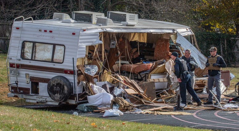 Police examine a stolen RV after ramming it multiple times with an armored vehicle while searching for a Marine deserter who is wanted for questioning in a murder case, in Roanoke, Va. Police examine a stolen RV after ramming it multiple times with an armored vehicle while searching for a Marine deserter who is wanted for questioning in a murder case, in Roanoke, Va.