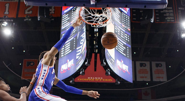 Philadelphia 76ers' Matisse Thybulle, center, dunks the ball with New York Knicks' Dennis Smith Jr., left, defending during the first half of an NBA basketball game, Wednesday, Nov. 20, 2019, in Philadelphia. Philadelphia 76ers' Matisse Thybulle, center, dunks the ball with New York Knicks' Dennis Smith Jr., left, defending during the first half of an NBA basketball game, Wednesday, Nov. 20, 2019, in Philadelphia.