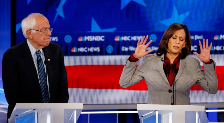 Democratic presidential candidate Sen. Kamala Harris, D-Calif., speaks as Democratic presidential candidate Sen. Bernie Sanders, I-Vt., listens during a Democratic presidential primary debate, Wednesday, Nov. 20, 2019, in Atlanta. Democratic presidential candidate Sen. Kamala Harris, D-Calif., speaks as Democratic presidential candidate Sen. Bernie Sanders, I-Vt., listens during a Democratic presidential primary debate, Wednesday, Nov. 20, 2019, in Atlanta.