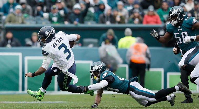 Seattle Seahawks' Russell Wilson, left, tries to avoid Philadelphia Eagles' Rodney McLeod during the first half of an NFL football game, Sunday, Nov. 24, 2019, in Philadelphia. Seattle Seahawks' Russell Wilson, left, tries to avoid Philadelphia Eagles' Rodney McLeod during the first half of an NFL football game, Sunday, Nov. 24, 2019, in Philadelphia.
