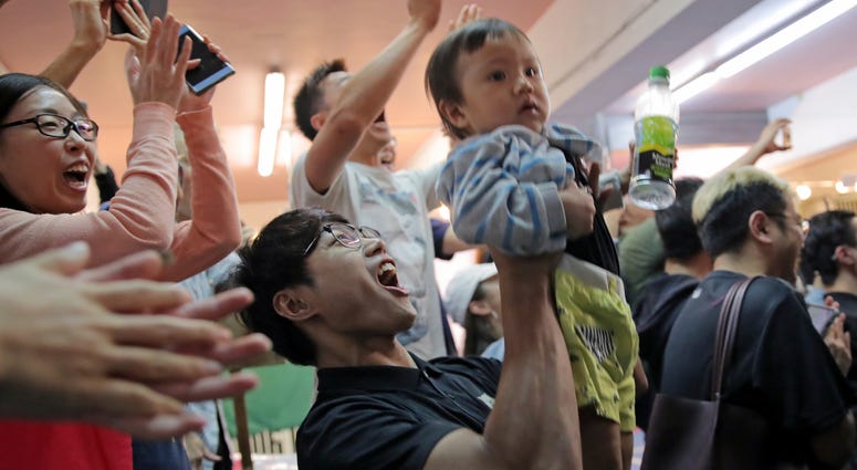 Pro-democracy supporters celebrate after pro-Beijing politician Junius Ho lost his election in Hong Kong, early Monday, Nov. 25, 2019. Pro-democracy supporters celebrate after pro-Beijing politician Junius Ho lost his election in Hong Kong, early Monday, Nov. 25, 2019.