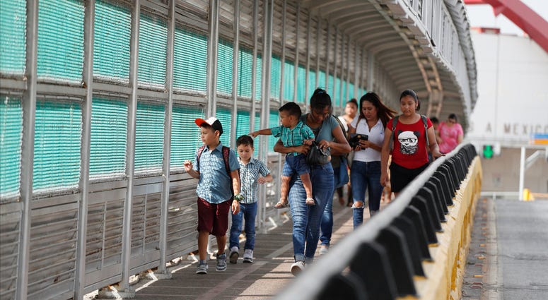 Local residents with visas walk across the Puerta Mexico international bridge to enter the U.S., in Matamoros, Tamaulipas state, Mexico. Local residents with visas walk across the Puerta Mexico international bridge to enter the U.S., in Matamoros, Tamaulipas state, Mexico.