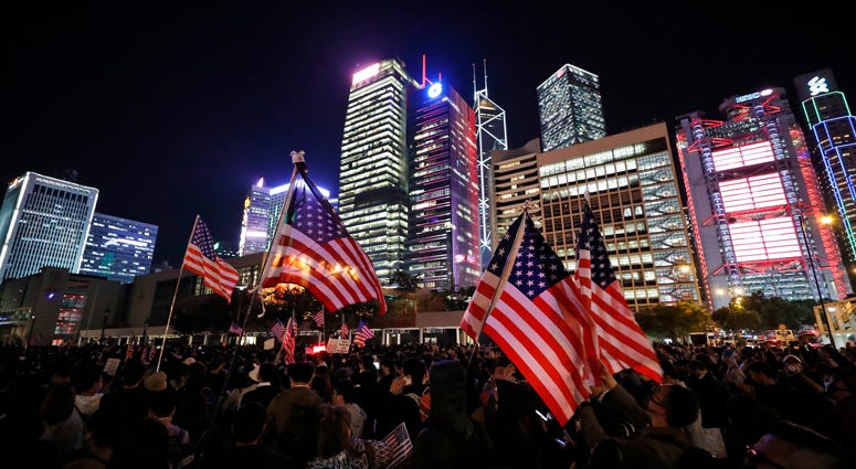 Protesters hold U.S. flags during a demonstration in Hong Kong, Thursday, Nov. 28, 2019. Protesters hold U.S. flags during a demonstration in Hong Kong, Thursday, Nov. 28, 2019.