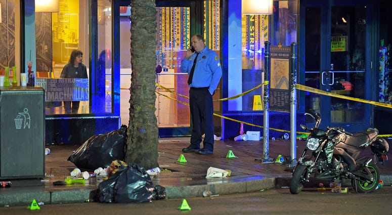 A woman looks out from inside a McDonald's fast food restaurant as New Orleans police investigate the scene of a shooting Sunday, Dec. 1, 2019, on the edge of the city's famed French Quarter. A woman looks out from inside a McDonald's fast food restaurant as New Orleans police investigate the scene of a shooting Sunday, Dec. 1, 2019, on the edge of the city's famed French Quarter.
