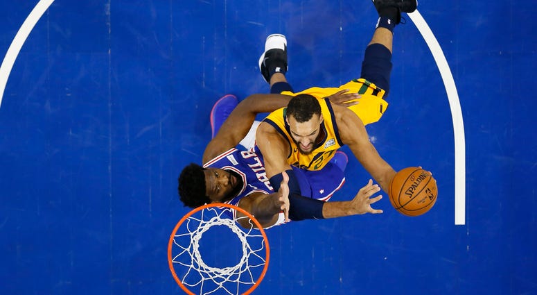 Utah Jazz's Rudy Gobert, right, goes up to shoot against Philadelphia 76ers' Joel Embiid during the first half of an NBA basketball game, Monday, Dec. 2, 2019, in Philadelphia. Utah Jazz's Rudy Gobert, right, goes up to shoot against Philadelphia 76ers' Joel Embiid during the first half of an NBA basketball game, Monday, Dec. 2, 2019, in Philadelphia.