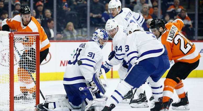 Philadelphia Flyers' Scott Laughton (21) scores a goal past Toronto Maple Leafs' Frederik Andersen (31) as Justin Holl (3) and Morgan Rielly (44) defend during the second period of an NHL hockey game, Tuesday, Dec. 3, 2019, in Philadelphia. Philadelphia Flyers' Scott Laughton (21) scores a goal past Toronto Maple Leafs' Frederik Andersen (31) as Justin Holl (3) and Morgan Rielly (44) defend during the second period of an NHL hockey game, Tuesday, Dec. 3, 2019, in Philadelphia.