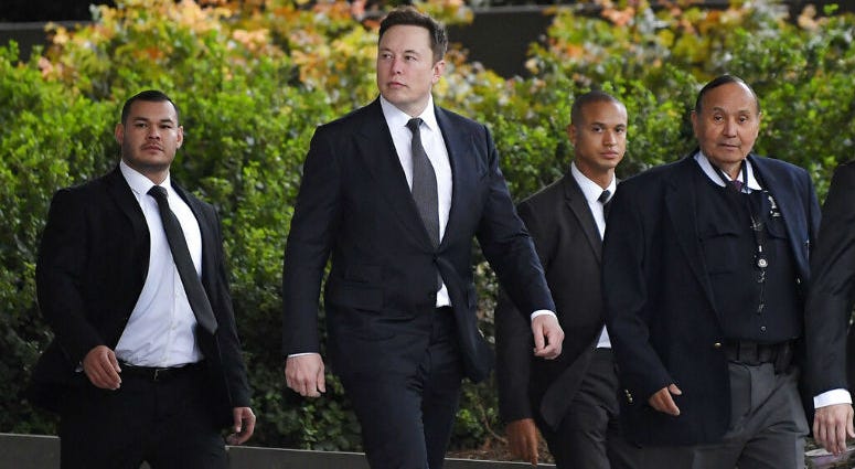 Tesla CEO Elon Musk, second from left, arrives at U.S. District Court Wednesday, Dec. 4, 2019, in Los Angeles. Tesla CEO Elon Musk, second from left.