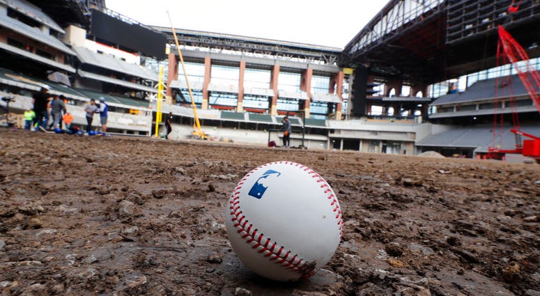 A baseball lies on packed dirt after for a short batting practice during a tour of the under construction baseball field at the new Texas Rangers stadium in Arlington, Texas, Wednesday, Dec. 4, 2019. A baseball lies on packed dirt after for a short batting practice during a tour of the under construction baseball field at the new Texas Rangers stadium in Arlington, Texas.