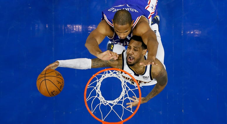 Denver Nuggets' Monte Morris, bottom, goes up for a shot against Philadelphia 76ers' Al Horford during the second half of an NBA basketball game, Tuesday, Dec. 10, 2019, in Philadelphia. Denver Nuggets' Monte Morris, bottom, goes up for a shot against Philadelphia 76ers' Al Horford during the second half of an NBA basketball game, Tuesday, Dec. 10, 2019, in Philadelphia.
