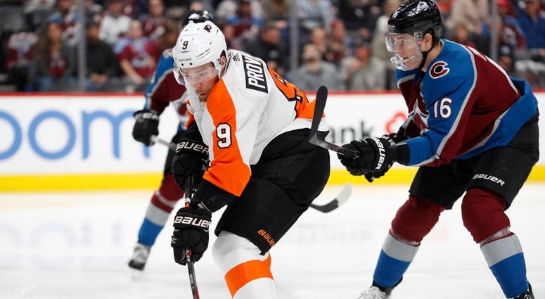 Philadelphia Flyers defenseman Ivan Provorov, left, fires the puck on the net after slipping pst Colorado Avalanche defenseman Nikita Zadorov in the second period of an NHL hockey game Wednesday, Dec. 11, 2019, in Denver. Philadelphia Flyers defenseman Ivan Provorov, left, fires the puck on the net after slipping pst Colorado Avalanche defenseman Nikita Zadorov in the second period of an NHL hockey game Wednesday, Dec. 11, 2019, in Denver.