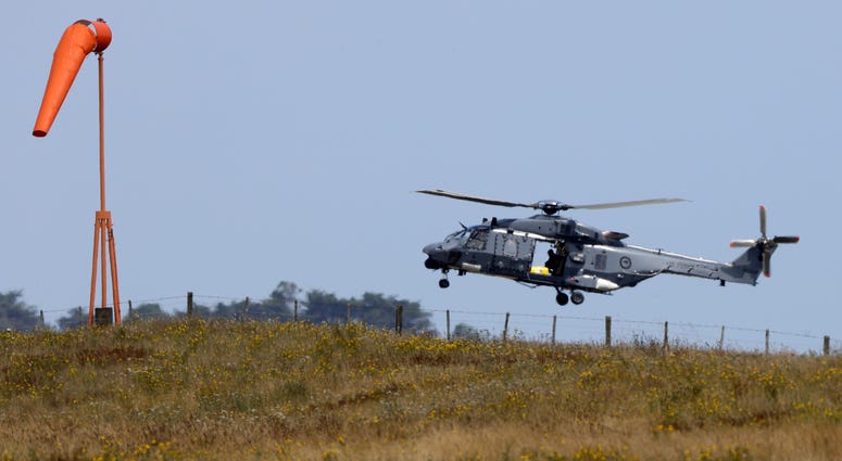 A Navy helicopter returns to Whakatane Airport following the recovery operation to return the victims of the Dec. 9 volcano eruption continues off the coast of Whakatane New Zealand, Friday, Dec. 13, 2019. Navy helicopter returns to Whakatane Airport