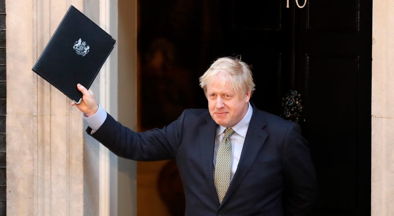 Britain's Prime Minister Boris Johnson waves after addressing the media outside 10 Downing Street in London Friday. Britain's Prime Minister Boris Johnson waves after addressing the media outside 10 Downing Street in London Friday.