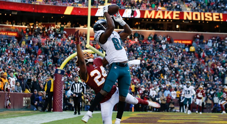 Philadelphia Eagles wide receiver Greg Ward (84) catches a touchdown pass beating out Washington Redskins cornerback Josh Norman (24) in the second half of an NFL football game, Sunday, Dec. 15, 2019, in Landover, Md. Eagles won 37-27. Greg Ward
