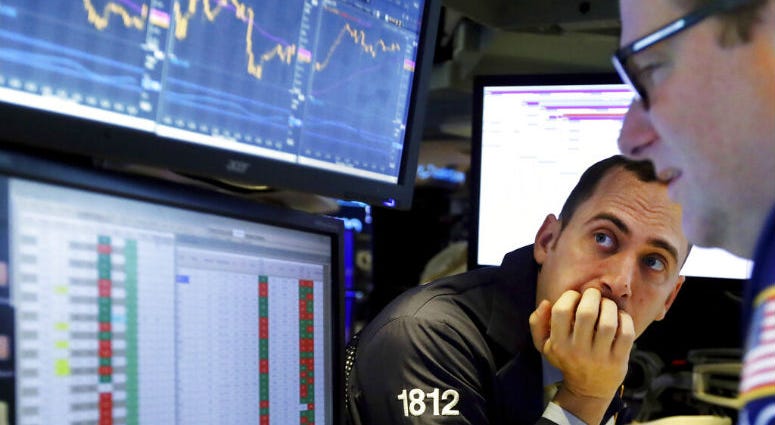 FILE - In this Nov. 14, 2019, file photo a pair of specialists work on the floor of the New York Stock Exchange. FILE - In this Nov. 14, 2019, file photo a pair of specialists work on the floor of the New York Stock Exchange.