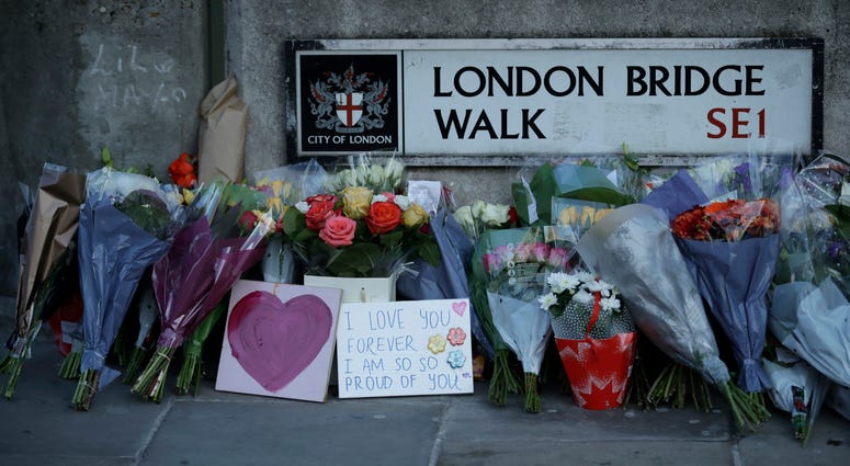 A mysterious figure who used a rare narwhal tusk to help subdue a knife-wielding extremist on London Bridge last month has been identified as a civil servant in Britain's Justice Ministry. Tributes are placed by the southern end of London Bridge on Dec. 2, three days after a man stabbed two people to death and injured three others before being shot dead by police, in London.