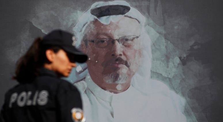 A Turkish police officer walks past a picture of slain Saudi journalist Jamal Khashoggi prior to a ceremony, near the Saudi Arabia consulate in Istanbul, marking the one-year anniversary of his death. A Turkish police officer walks past a picture of slain Saudi journalist Jamal Khashoggi prior to a ceremony, near the Saudi Arabia consulate in Istanbul, marking the one-year anniversary of his death.