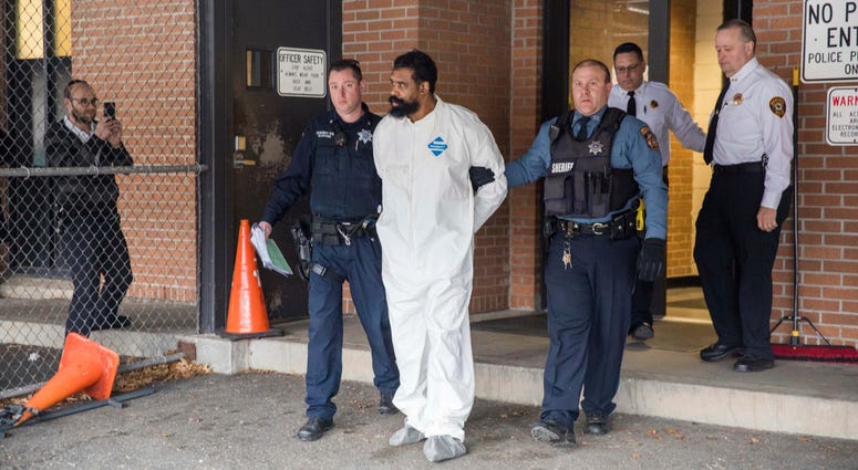 Ramapo police officers escort Grafton Thomas from Ramapo Town Hall to a police vehicle, Sunday, Dec. 29, 2019, in Ramapo, N.Y. Grafton Thomas